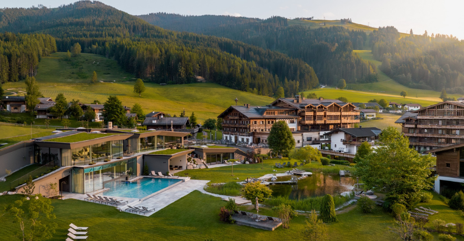 Naturresort Puradies in Leogang with outdoor pool and mountain views in a green alpine valley