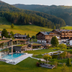 Naturresort Puradies in Leogang with outdoor pool and mountain views in a green alpine valley
