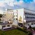 Osrodek Rehabilitacyjno Wypoczynkowy Wlokniarz in Ustka, multi-story hotel beside a road and trees