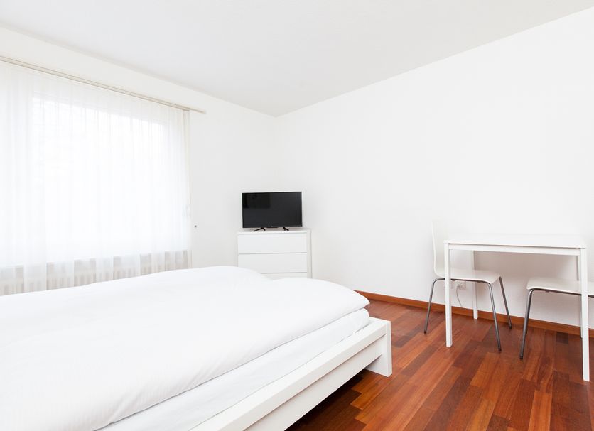 Swiss Star Zurich Airport - Self Check-In in Kloten: bright white hotel room with bed, TV and small table