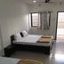 Vrp Guest House in Bhuj with simple guest room, two beds, window curtains, and tiled floor