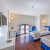 Adalya Port Hotel Antalya guest room with two blue upholstered beds and balcony doors
