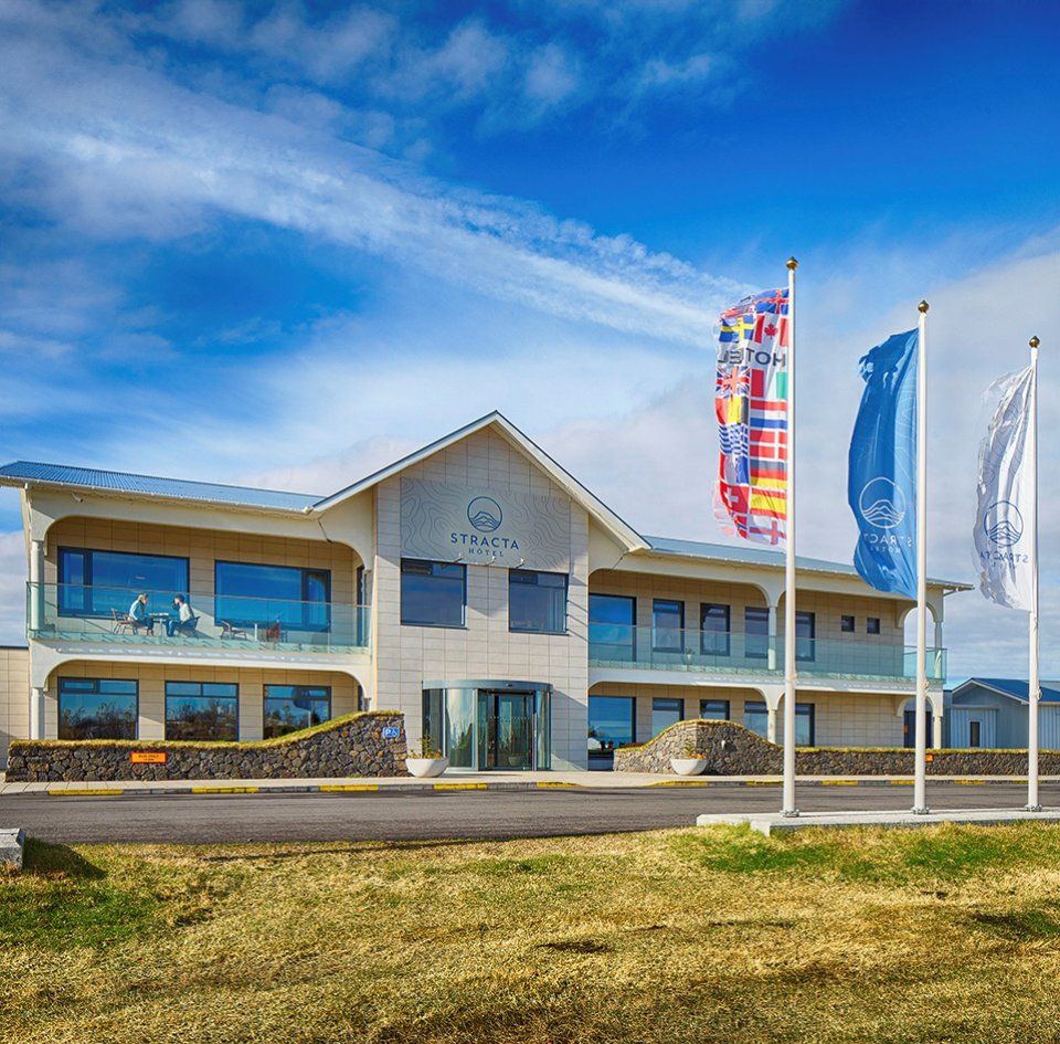 Stracta Hotel in Hella exterior with flags and blue sky