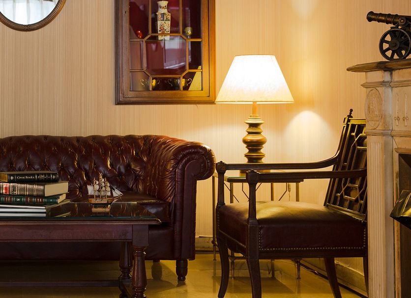 The Mayflower Hotel Beirut lounge with leather sofa, lamps, chairs, and coffee table