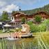 Familienparadies Sporthotel Achensee in Achenkirch, lakeside resort with dock, pond and mountain backdrop