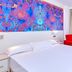 Indico Rock Hotel Mallorca - Adults Only room in Palma de Mallorca with red seating and bright balcony door