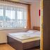 Family Homes - Dom Wakacyjny Eda room in Władysławowo with bed, desk, and large window