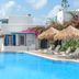 Aggeliki's Diamond in Agia Anna with a pool, sun loungers, and straw umbrellas beside white villas