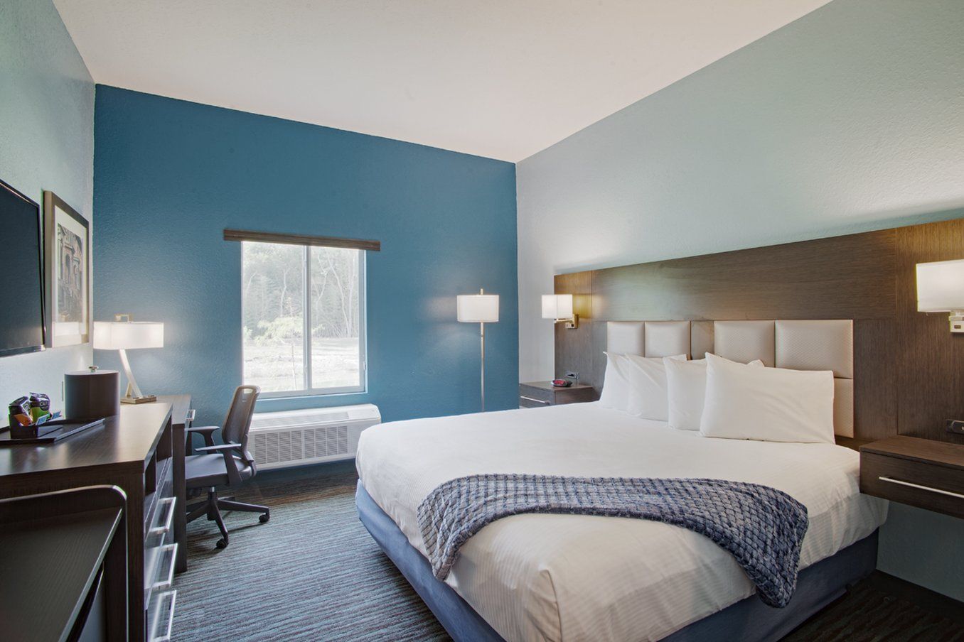 Iris Garden Inn in Garden City guest room with king bed, desk, chair, and window