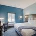Iris Garden Inn in Garden City guest room with king bed, desk, chair, and window
