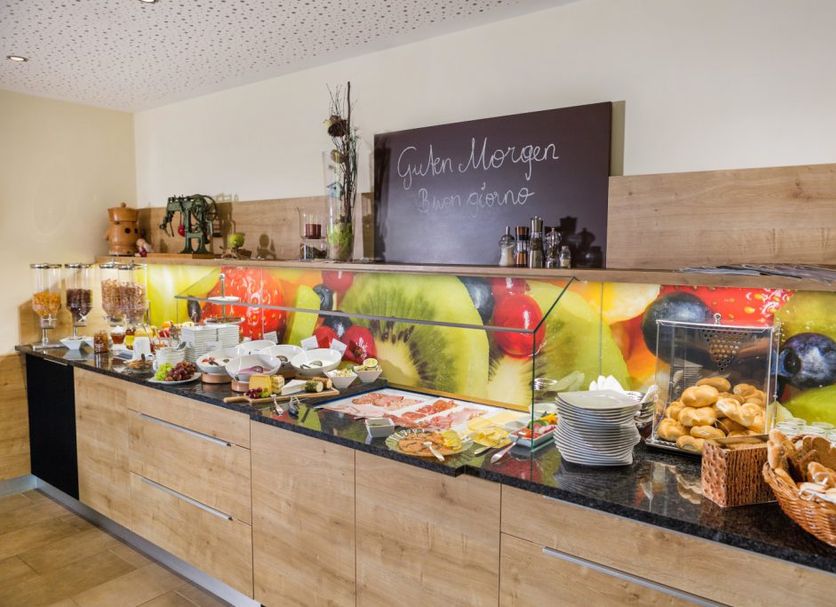 Breakfast buffet at Hotel Garni Sohler in Villach with pastries, fruit, cereal and coffee.