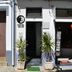 Hostel Seixe in Odeceixe storefront entrance with potted plants and open doorway