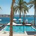 Amàre Beach Hotel Ibiza in Sant Antoni de Portmany with palm-framed infinity pool overlooking the sea
