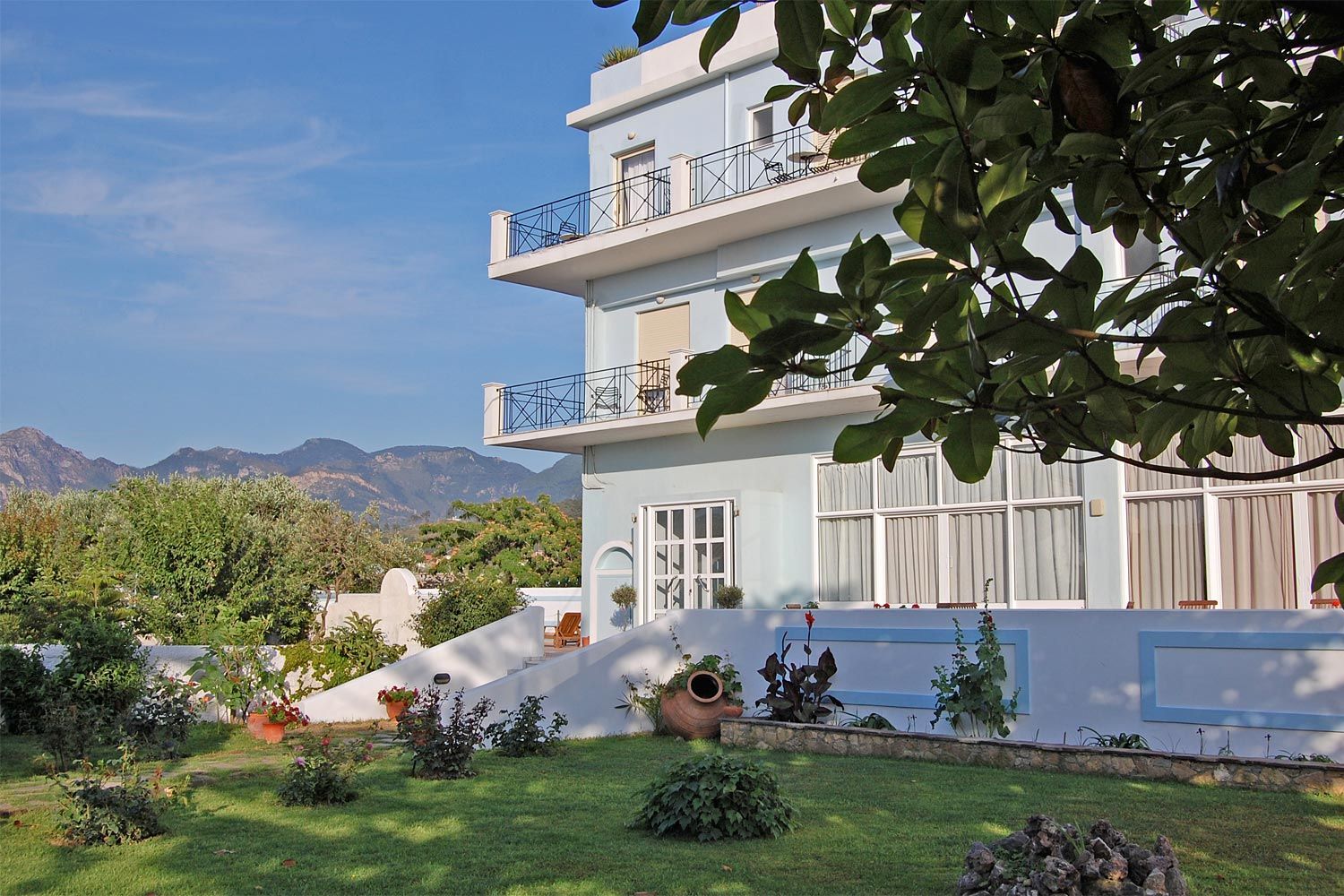 Astir Hotel in Karlovasi with balconies, garden, and mountain views