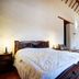 Tinto Hostel in Barichara room with carved wooden bed and dining table