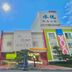 Shui Yue Boutique Motel in Taichung City exterior with palm tree and bright colorful facade