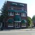 The Boardwalk Hotel in Saint Ignace, brick facade with green awnings and entrance