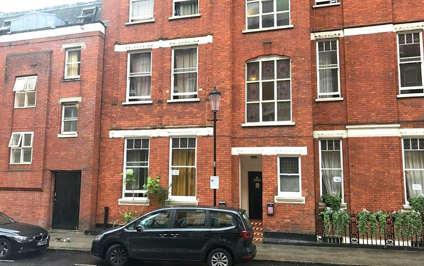 Barkston Rooms Earl's Court in London, red-brick hotel exterior on a street with parked cars