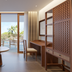 Paradisus by Meliá Bali room with sofa, desk and balcony opening to tropical views in South Kuta