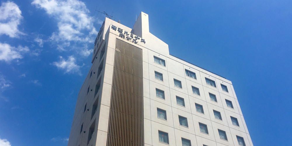 Akashi Luminous Hotel in Akashi, white mid-rise hotel against a blue sky