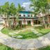 Pousada Tajupa in Pirenópolis with palm trees, stone walkway, and a grassy courtyard outside the lodge