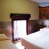 Le New Matinal in La Louvière guest room with twin beds and floral wall mural