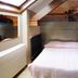 Le New Matinal in La Louvière guest room with single bed and cityscape wall mural