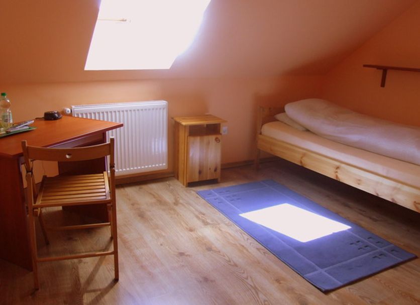 Motel Orzel in Szczecinek attic room with single bed, desk, skylight and wood floor