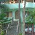 Sunrise Resort in Phan Thiet with a tropical garden and stone staircase leading to a turquoise bungalow.
