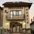 Pensiunea Maria in Calimanesti Caciulata, hotel facade with balcony, entrance and bicycle outside