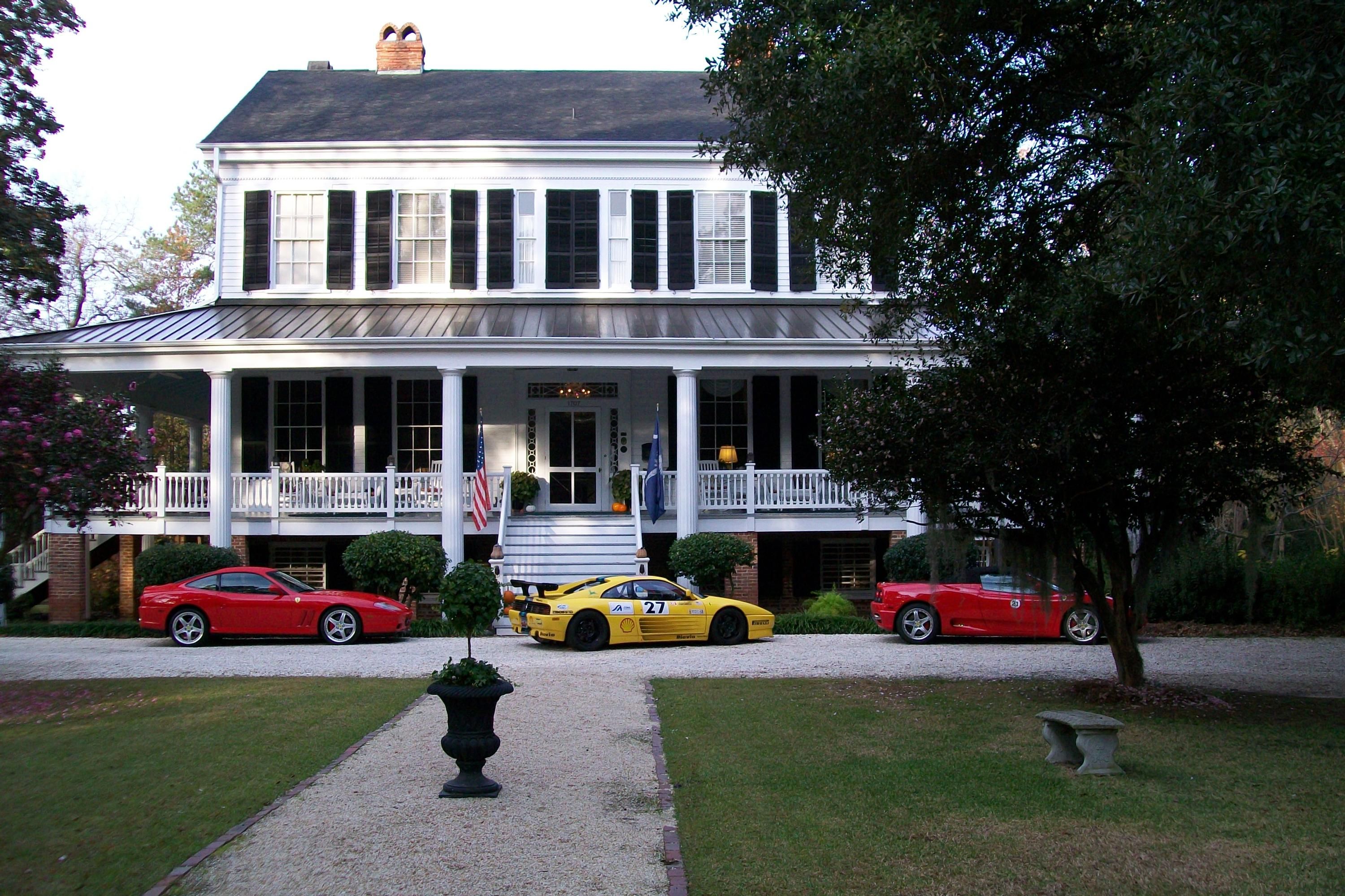 Bloomsbury Inn in Camden with a white two-story porch house and classic cars parked out front