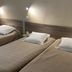 Angleterre Hotel in Paris guest room with three single beds and wall-mounted reading lights