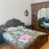 Kharkovlux in Kharkiv bedroom with ornate carved wooden bed and mirrored wardrobe