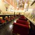 Umaid Mahal heritage hotel in Jaipur with ornate corridor seating and mural-decorated walls