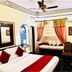 Umaid Mahal, Jaipur guest room with bed, window seat, ceiling fan and air conditioner