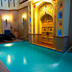 Umaid Mahal, Jaipur indoor pool with ornate Rajasthani archway and lounge chairs
