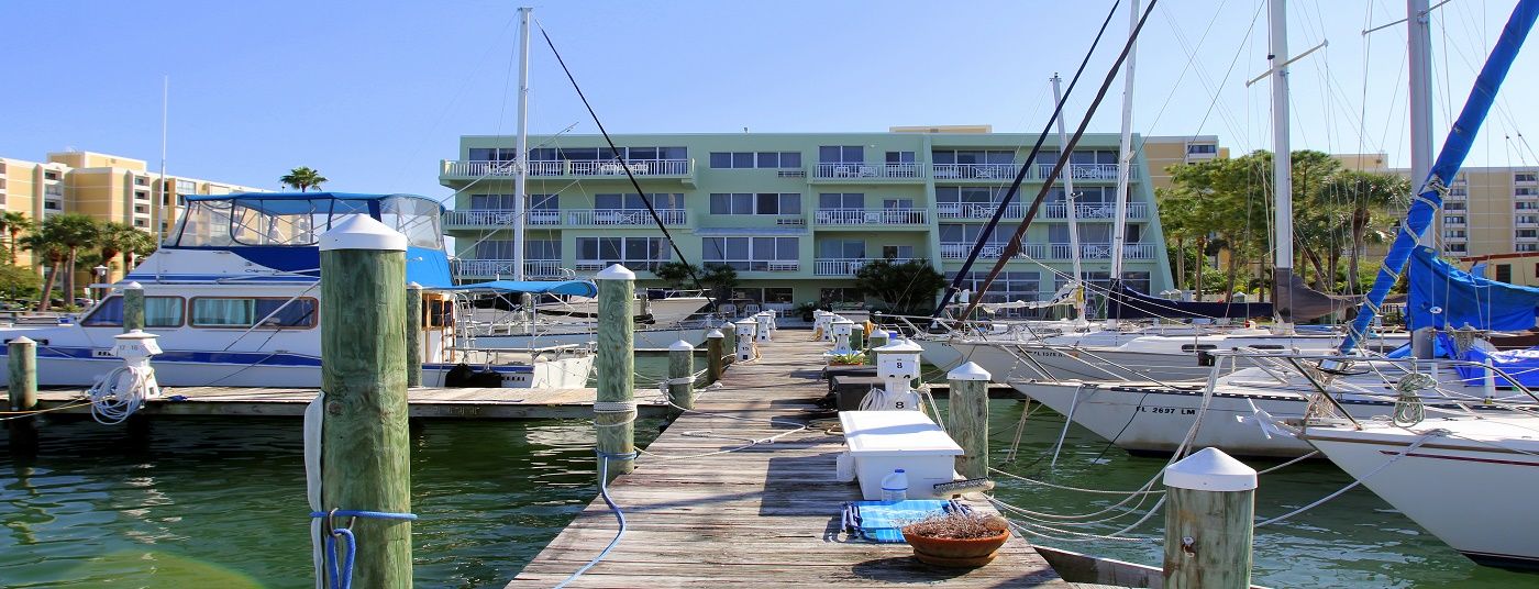 Chart House Suites and Marina in Clearwater Beach with a marina dock, sailboats, and waterfront hotel view