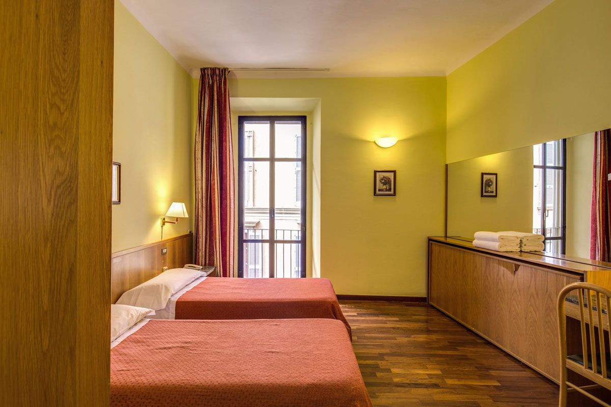 Hotel Vecchia Milano in Milan guest room with twin beds, balcony doors, and wall mirror