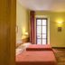 Hotel Vecchia Milano in Milan guest room with twin beds, balcony doors, and wall mirror