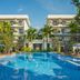 Koulen Hotel in Siem Reap with a large outdoor pool, lounge chairs, umbrellas, and palm trees
