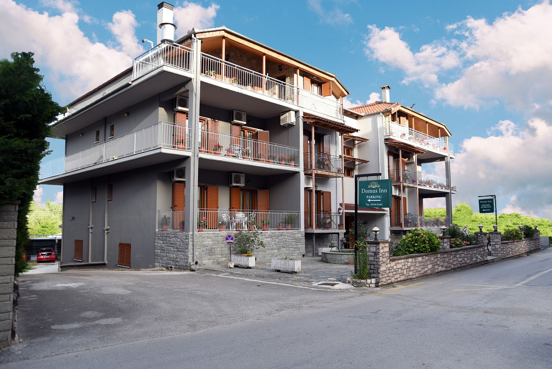 Domus Inn in Ioánnina, three-story hotel with balconies and mountain-view setting