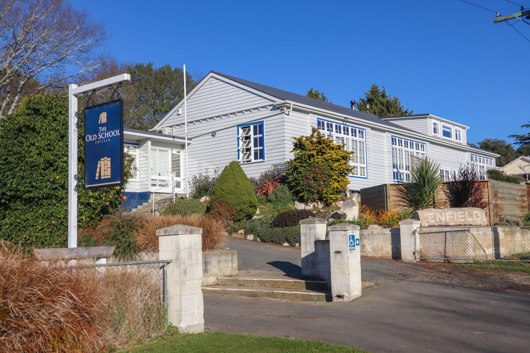The Old School Enfield in Oamaru, white hotel exterior with landscaped entrance and driveway