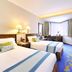 The Kimberley Hotel Hong Kong twin guest room with two beds, desk by window, and patterned blue carpet