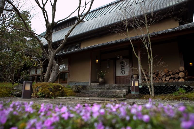 Sanso Murata in Yufu with a traditional inn exterior and purple flowers in the foreground